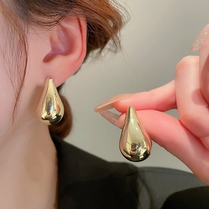 Minimalist golden teardrop earrings with a polished metallic finish and sleek convex design