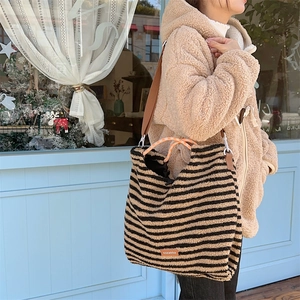 Vintage black and beige striped fuzzy shoulder bag with soft plush texture for winter