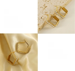 Detail of 18K gold plated hoop earrings with Greek key pattern and CZ stones