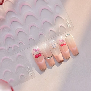 Detail of pink gradient French nail stickers with 3D cherry bow and gemstone accents