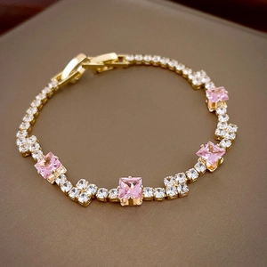 Elegant gold tennis bracelet with square pink gemstones and sparkling white zircons