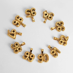 Polished 18K gold plated 90s number pendants arranged in a circle on white background