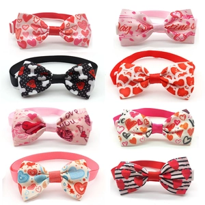 Detail view of 8 Valentine's dog bowties featuring red hearts and adjustable buckles