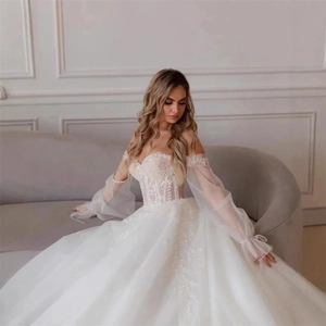 Elegant off-shoulder bridal gown with lace embroidery, puff sleeves and a full ball skirt