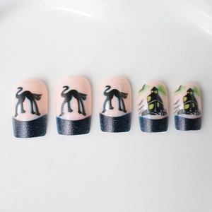 Short oval Halloween press-on nails with black cats, castles and blue shimmer french tips