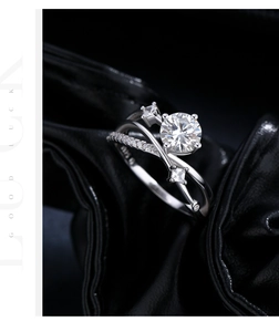 Close-up of S925 silver ring featuring 1ct moissanite on luxury black silk background