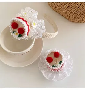 Detailed view of handmade cherry cake hairband with lace trim and knit texture