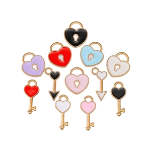 Detailed view of colorful heart lock and key charms in various enamel finish colors