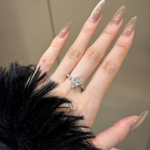 Close-up of S925 sterling silver ring with pear-cut zircon on a finger