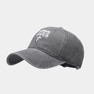 Detail of washed cotton baseball cap with white printed text and religious cross