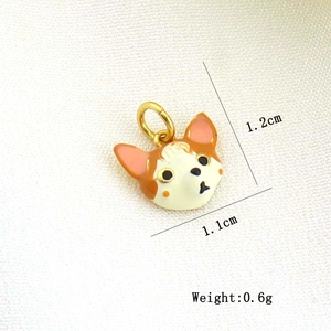 Close-up of small orange and cream enamel cat charm in golden finish for DIY jewelry