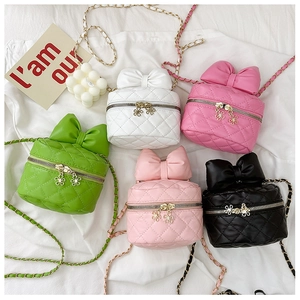 Top view of five colorful quilted bow handbags with floral zippers and chain straps