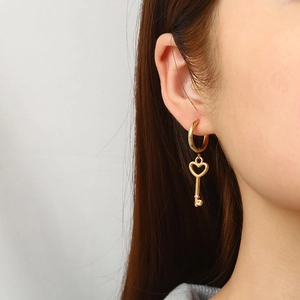 18K gold plated stainless steel heart key dangle earrings worn by a model