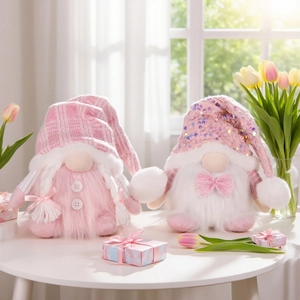 Luminous pink Christmas gnome plush dolls with sequined hats on a white table