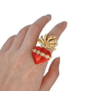 Adjustable gold plated sacred heart ring with red enamel and zircon on female finger