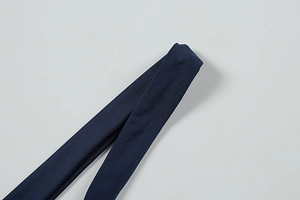 Macro shot of navy blue ribbed knit fabric on a stylish summer halter evening dress