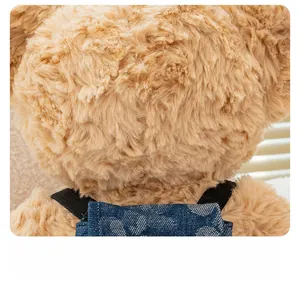 Close-up of soft plush teddy bear fur texture and miniature blue denim backpack detail