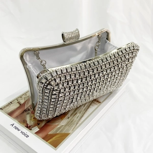 Detail view of silver rhinestone evening bag with satin lining and metal chain strap