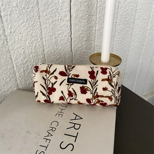French vintage corduroy floral makeup bag with metal zipper on minimalist white background