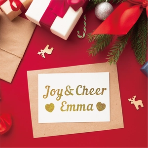 Detail of Christmas greeting card with gold glitter printing on red festive background