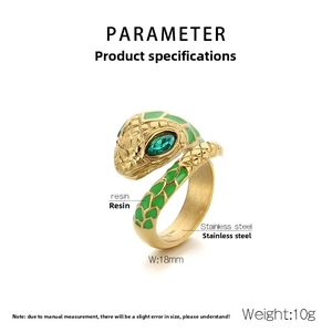 Detailed macro of golden snake ring with green emerald eyes and textured scales