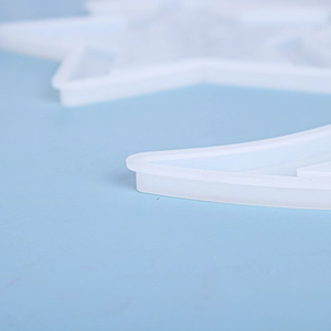 Macro detail of crescent moon and star shapes in translucent silicone resin molds