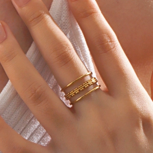 Three-piece stackable gold rings set featuring polished finish and beaded textures for women