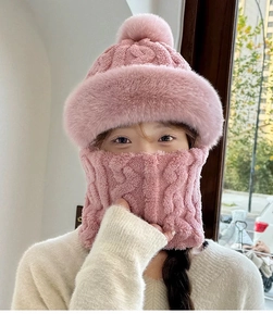 Detail of pink knitted hat and scarf set featuring plush faux fur lining and pom-pom
