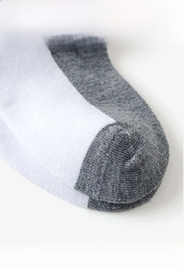 Macro detail of breathable mesh cotton socks with blue and grey reinforced stitching