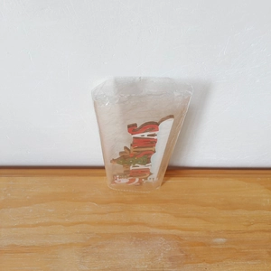 Detailed view of 3D wooden Christmas letter door frame decor in clear retail packaging