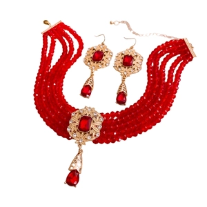 Vintage style multi-strand red bead necklace set with gold pendants and matching earrings