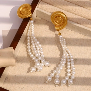 Golden spiral stud earrings with white pearl tassels in ocean beach style for women