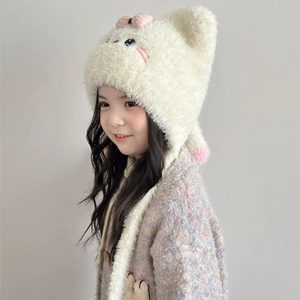 Detail of plush cat ear winter hat with embroidered face and knit bow on child