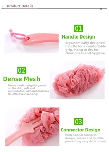 Close-up of pink mesh loofah and ergonomic long handle on a shower back brush