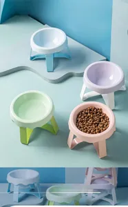 Close-up of macaron colored ceramic pet bowls with elevated detachable support stands