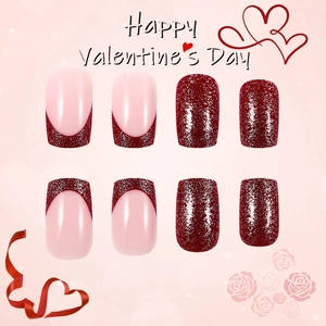 Detailed view of short square press-on nails with pink glitter heart and red finish