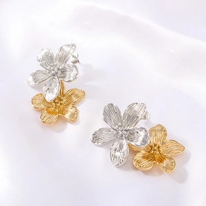French vintage flower earrings in two-tone gold and silver finish on white silk