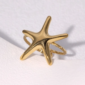 Minimalist gold starfish ring with a textured band on a clean white background