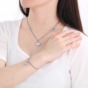 Detail showing 18K gold-plated stainless steel double-layered heart necklace and bracelet set