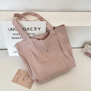 Close-up of pink striped canvas tote bag with you are so special embroidery detail