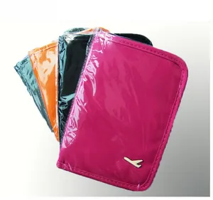 Macro shot of multi-color travel passport holders in nylon with metal airplane detail