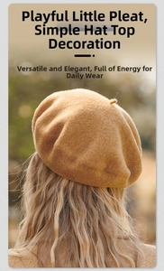Detail of the chic wool beret in camel showing high-quality fabric texture and top stalk