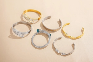 Detailed collection of gold and silver bangles with zircons and twisted textures
