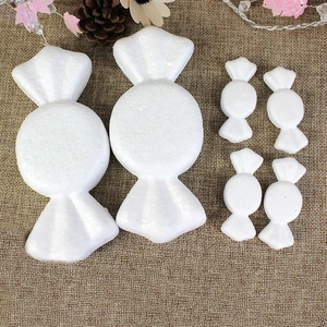 White styrofoam candy-shaped DIY molds for Christmas crafts on rustic burlap background