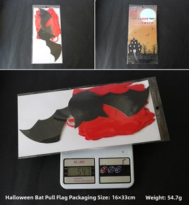 Detail view of red and black glitter bat banner with Halloween packaging and weight scale