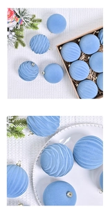 Detail showing blue velvet Christmas balls with spiral patterns on white knit fabric