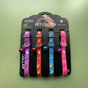 Set of four colorful silicone pet collars with bells in purple, red, blue, and pink
