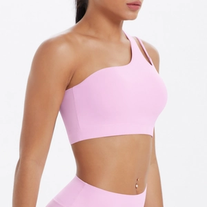 Pink one-shoulder sports bra featuring an asymmetrical cutout strap and elastic yoga fabric