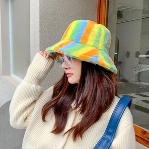 Detailed close-up of rainbow striped plush bucket hat texture in natural outdoor light