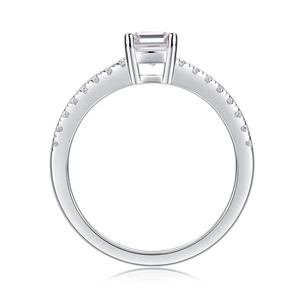 Macro view of emerald-cut moissanite ring with pavé-set diamonds on S925 silver band